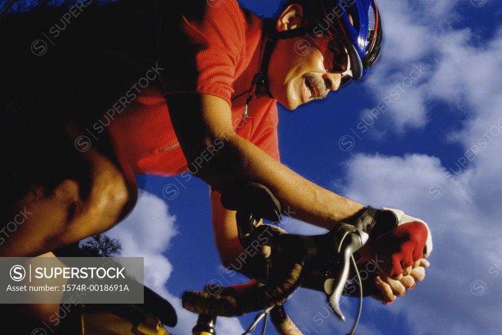 Stock Photo: 1574R-0018691A Low angle view of a mid adult man cycling