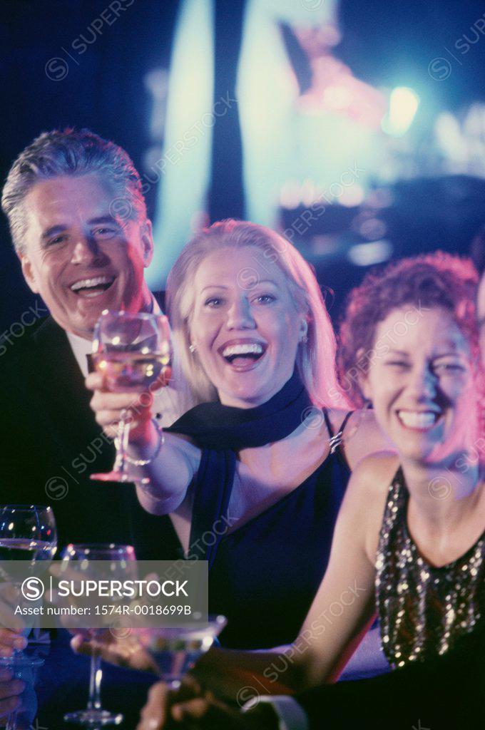 Stock Photo: 1574R-0018699B Portrait of two mature women and a mature man toasting with wineglasses