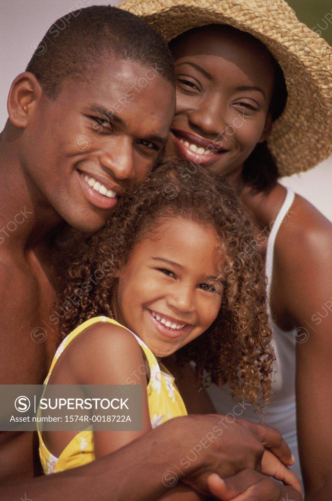 Stock Photo: 1574R-0018722A Portrait of parents and their daughter smiling