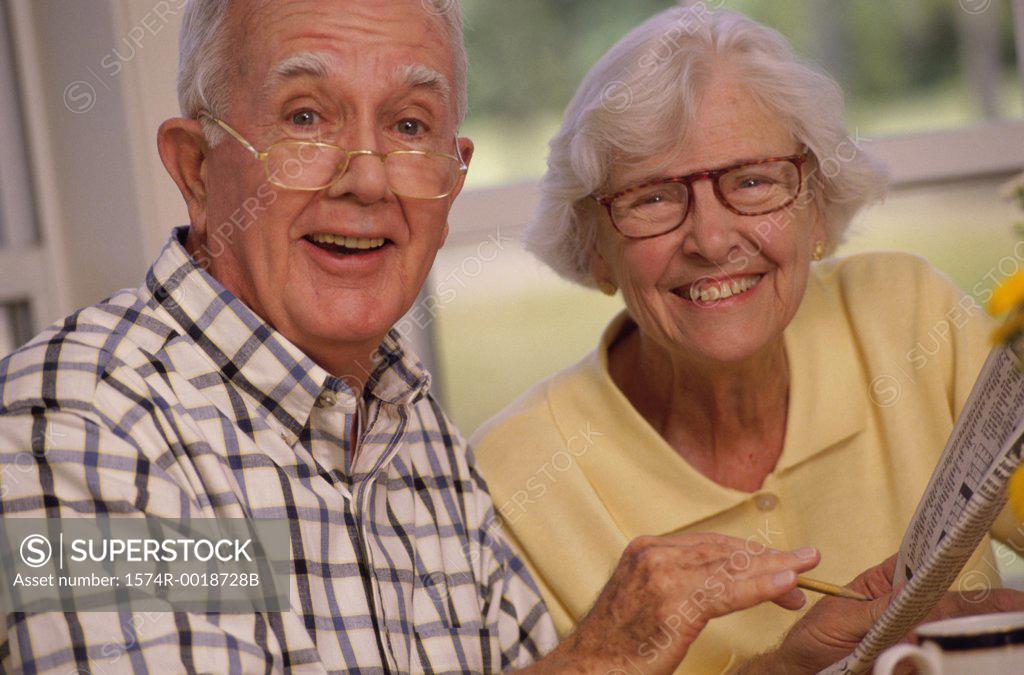 Stock Photo: 1574R-0018728B Senior couple with a crossword puzzle
