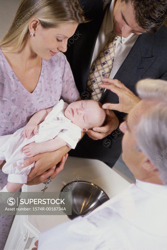 Stock Photo: 1574R-0018734A Close-up of parents with their son at a baptism