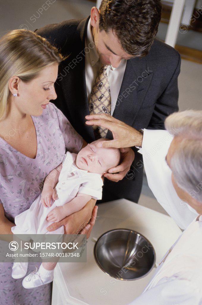 Stock Photo: 1574R-0018734B Close-up of parents with their son at a baptism