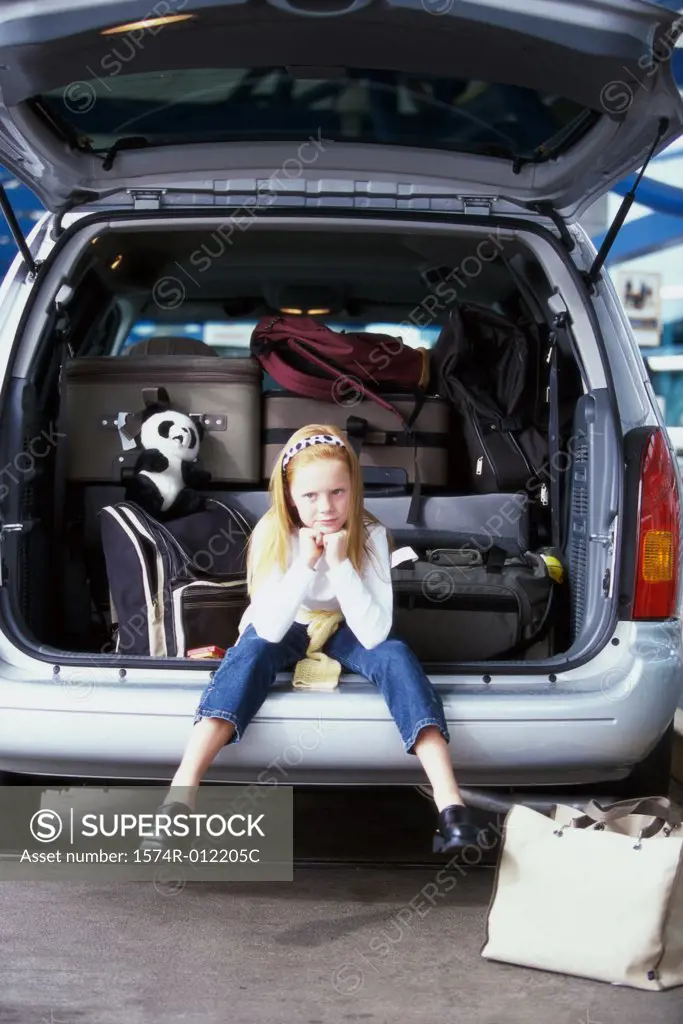 Girl sitting in the back of a car