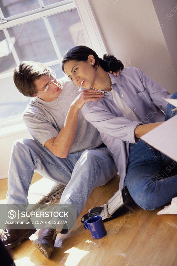 Stock Photo: 1574R-012337A High angle view of a young couple sitting on the floor