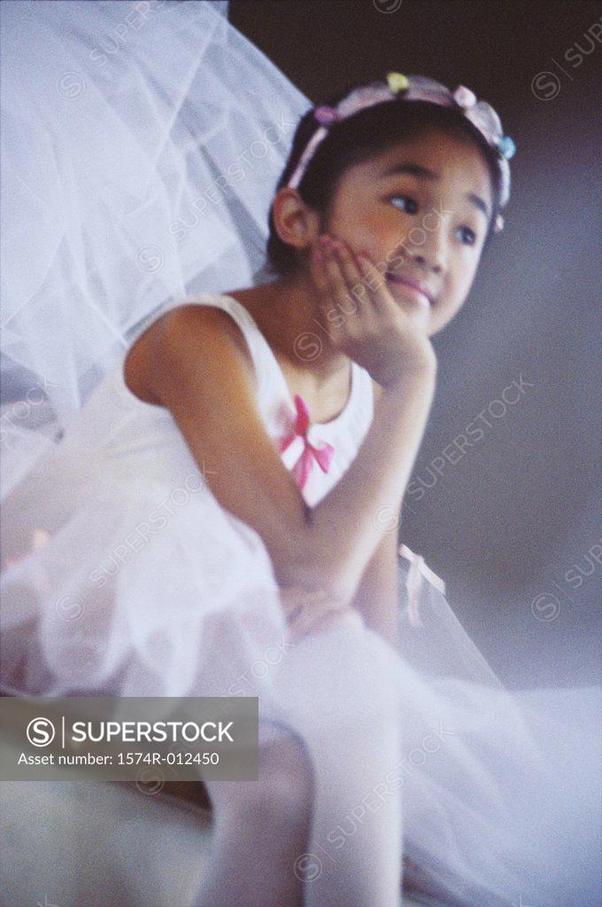 Stock Photo: 1574R-012450 Close-up of a ballerina sitting with her hand on her chin