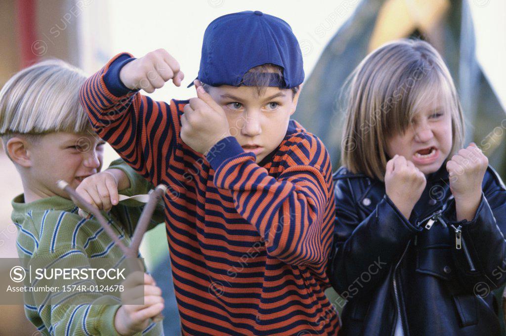 Stock Photo: 1574R-012467B Girl and two boys showing their fists in anger
