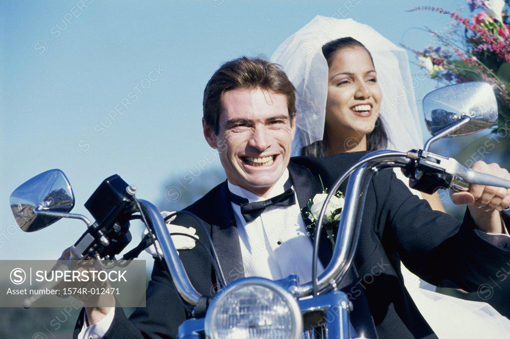 Stock Photo: 1574R-012471 Close-up of a newlywed couple riding a motorcycle