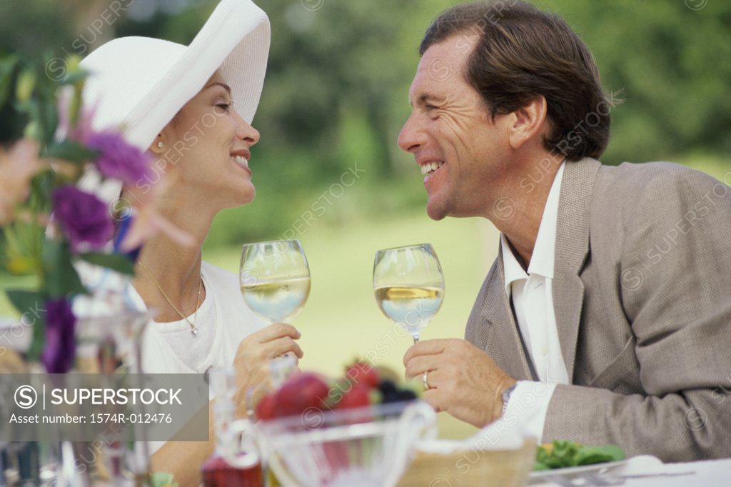 Stock Photo: 1574R-012476 Side profile of a mature couple holding wineglasses
