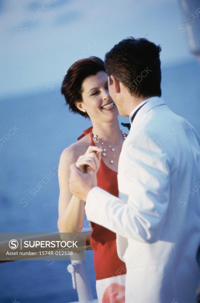 Stock Photo: 1574R-012538 Young couple dancing on the deck of a cruise ship