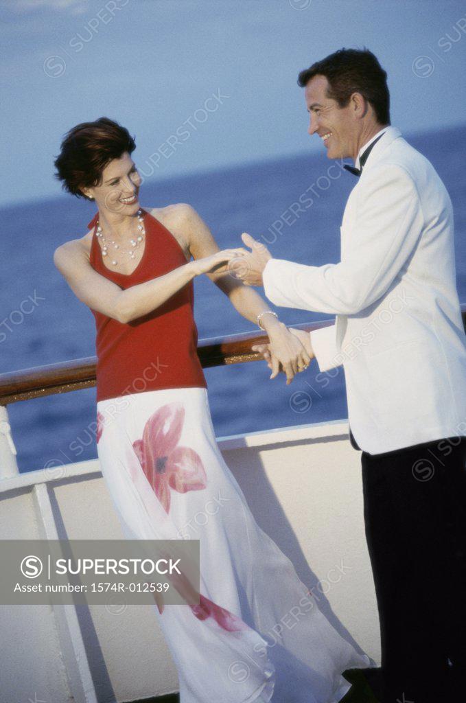 Stock Photo: 1574R-012539 Young couple dancing on the deck of a cruise ship