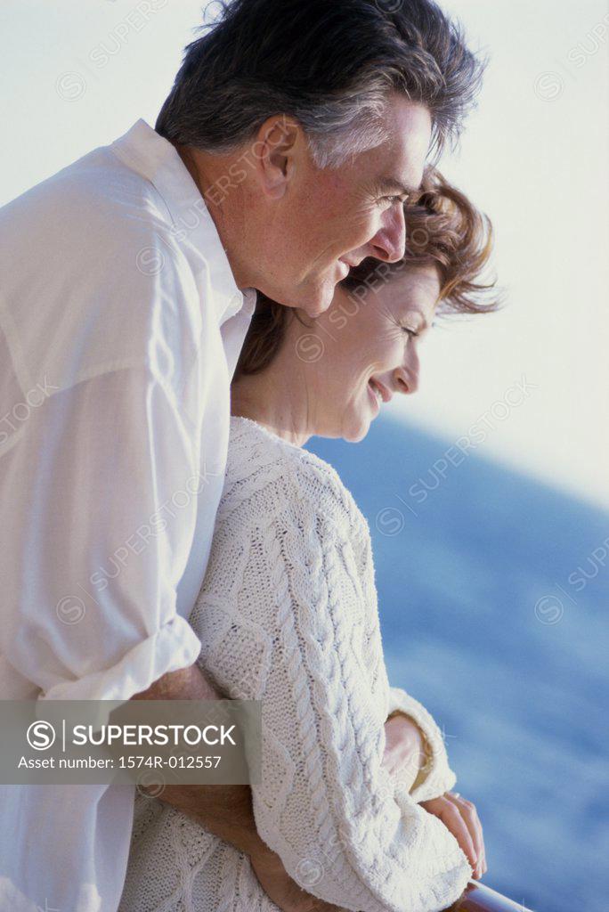 Stock Photo: 1574R-012557 Side profile of a senior couple embracing