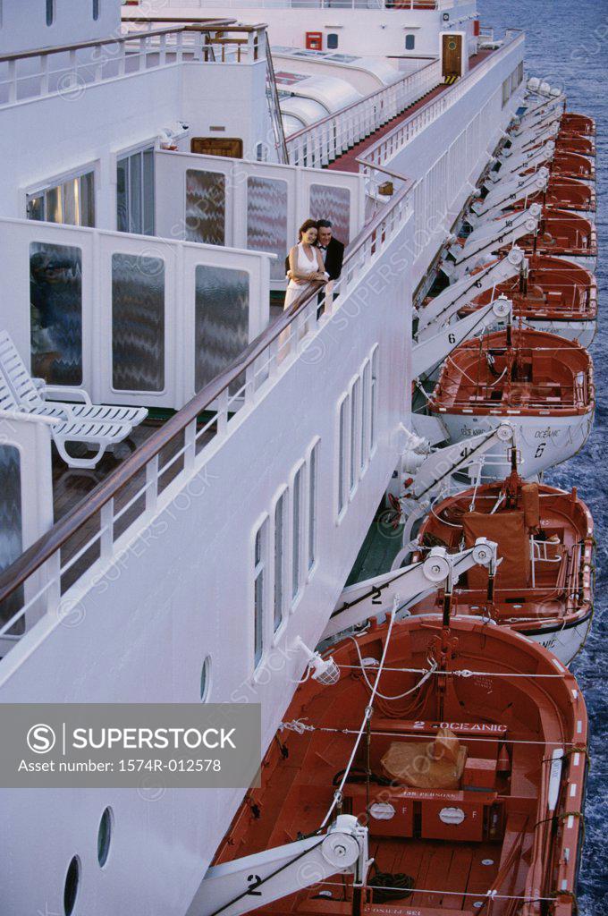 Stock Photo: 1574R-012578 High angle view of a mid adult couple standing on the deck of a cruise ship