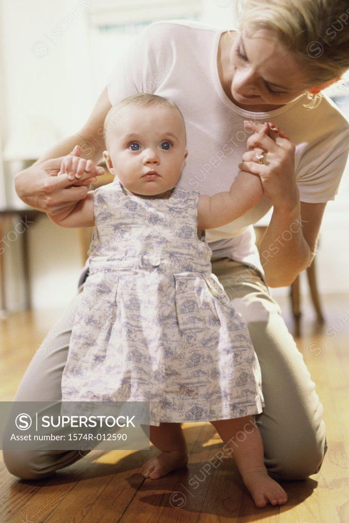 Stock Photo: 1574R-012590 Close-up of a mother teaching her daughter to walk