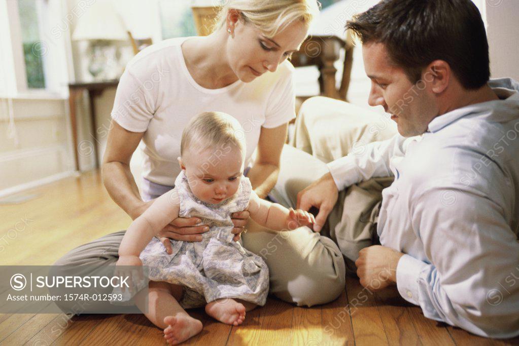 Stock Photo: 1574R-012593 Parents looking at their daughter smiling