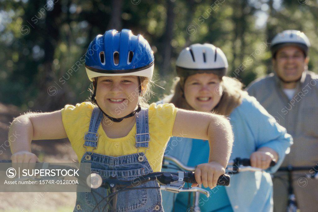 Stock Photo: 1574R-012800A Daughter cycling with her parents