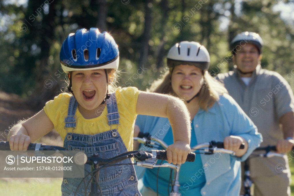 Stock Photo: 1574R-012800E Daughter cycling with her parents