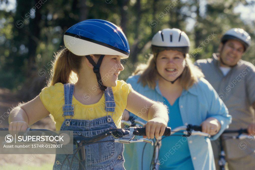 Stock Photo: 1574R-012800T Daughter cycling with her parents