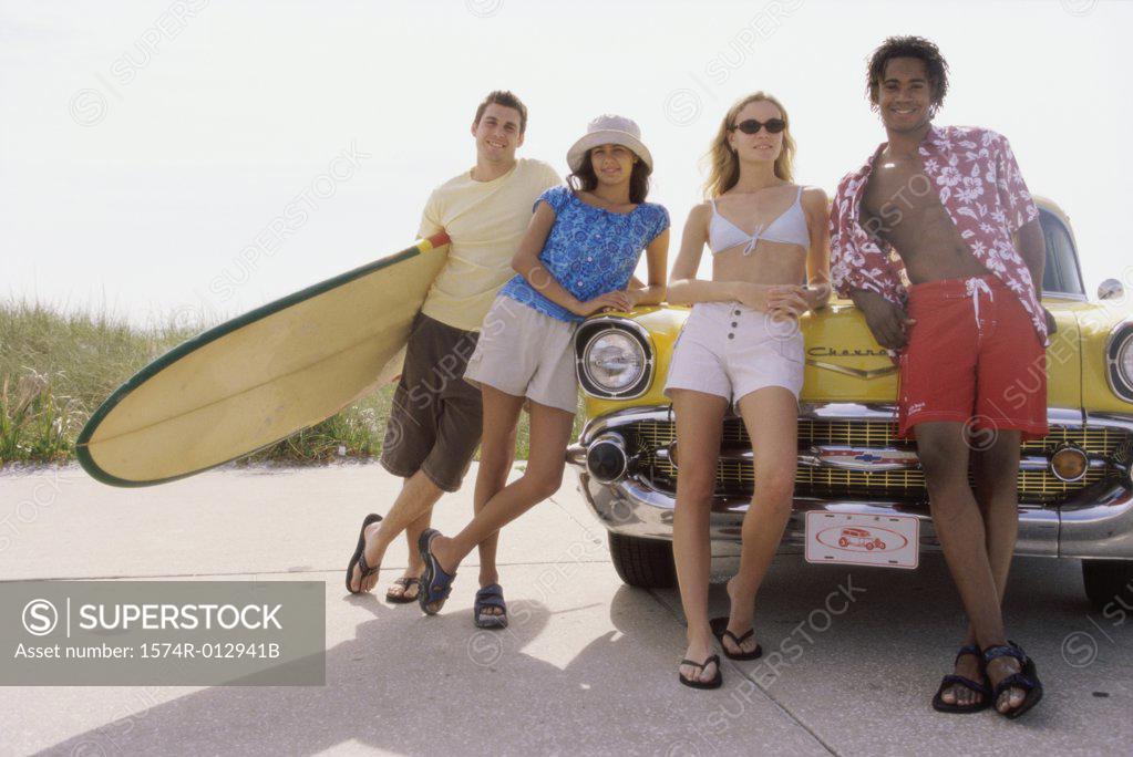Stock Photo: 1574R-012941B Two teenage couples leaning against a car