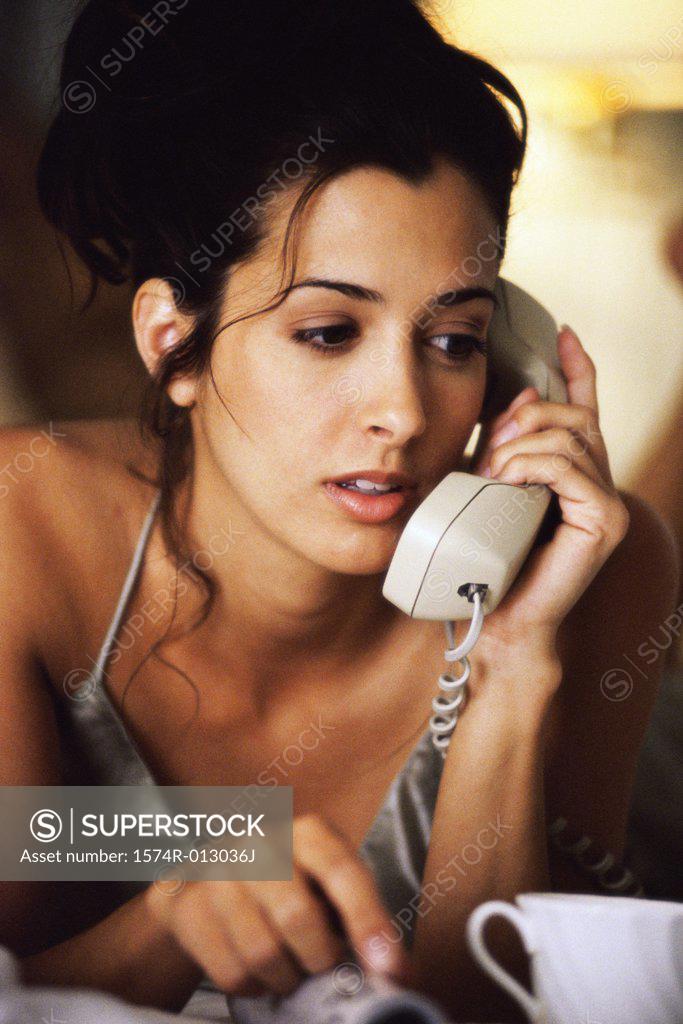 Stock Photo: 1574R-013036J Close-up of a young woman talking on the telephone