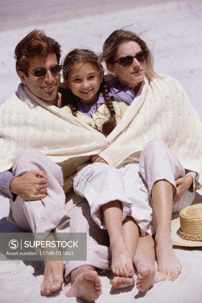 Stock Photo: 1574R-013863 High angle view of parents and their daughter sitting on the beach
