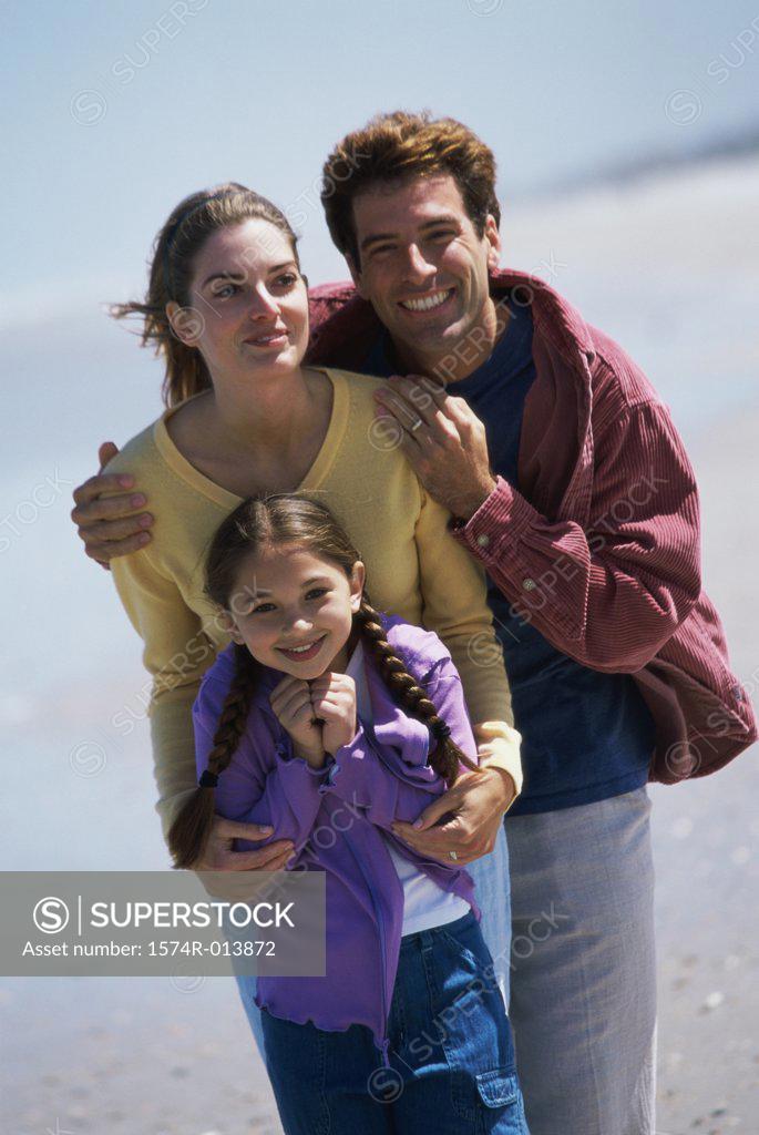 Stock Photo: 1574R-013872 Parents and their daughter standing on the beach