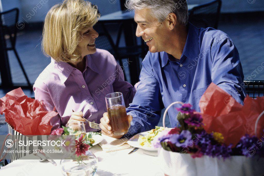 Stock Photo: 1574R-01388A Couple sitting at a table outdoors