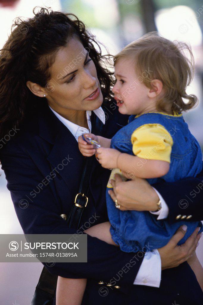 Stock Photo: 1574R-013895A Close-up of a mother consoling her baby