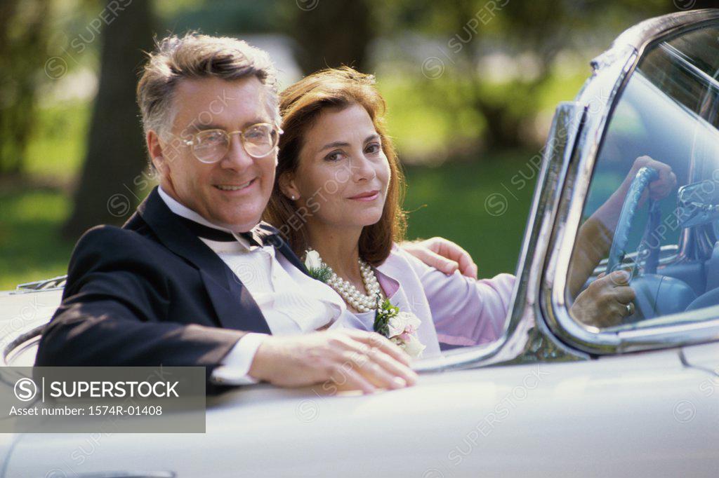 Stock Photo: 1574R-01408 Portrait of a couple sitting in a convertible car