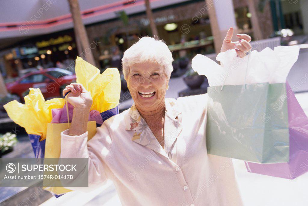 Stock Photo: 1574R-01417B Senior woman carrying shopping bag