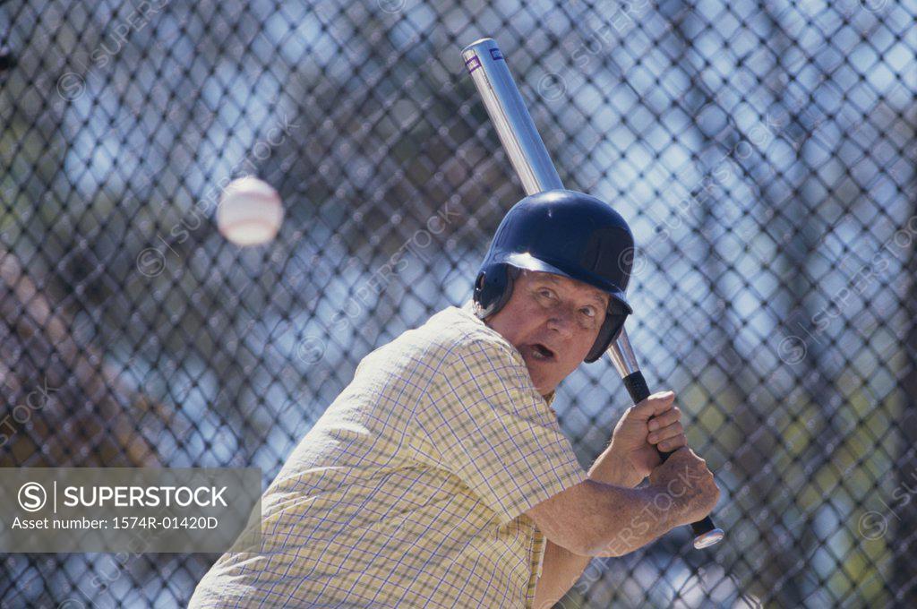 Stock Photo: 1574R-01420D Senior man playing baseball