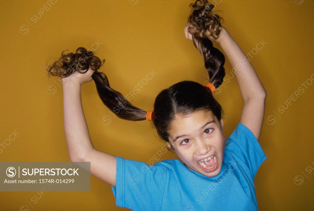 Stock Photo: 1574R-014299 Close-up of a girl pulling her hair