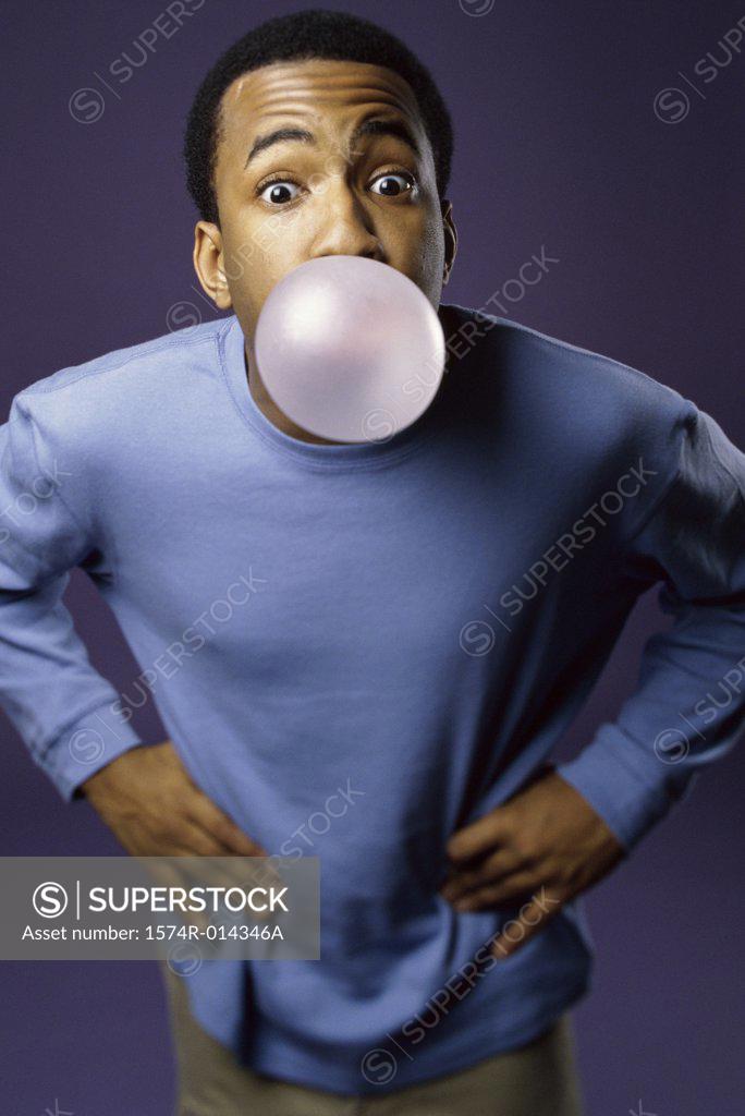 Stock Photo: 1574R-014346A Portrait of a young man blowing a bubble