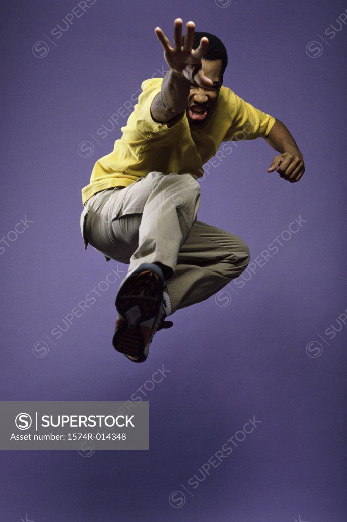 Stock Photo: 1574R-014348 Low angle view of a young man jumping