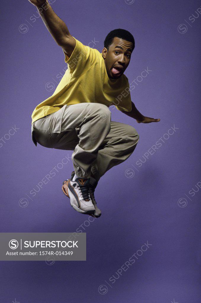 Stock Photo: 1574R-014349 Portrait of a young man jumping
