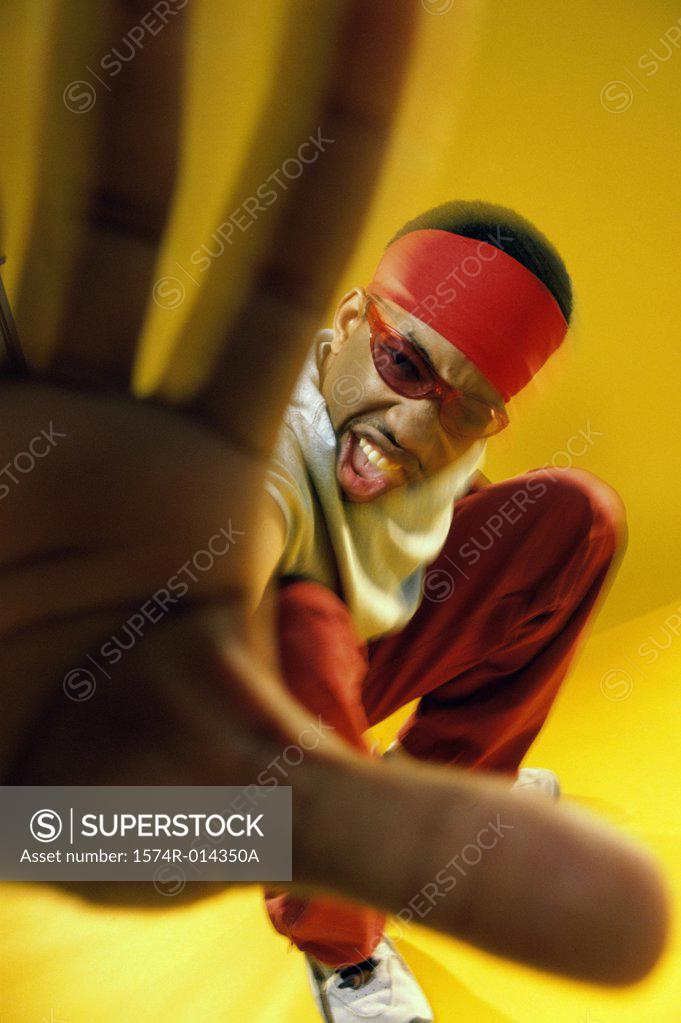 Stock Photo: 1574R-014350A Portrait of a young man showing a stop gesture