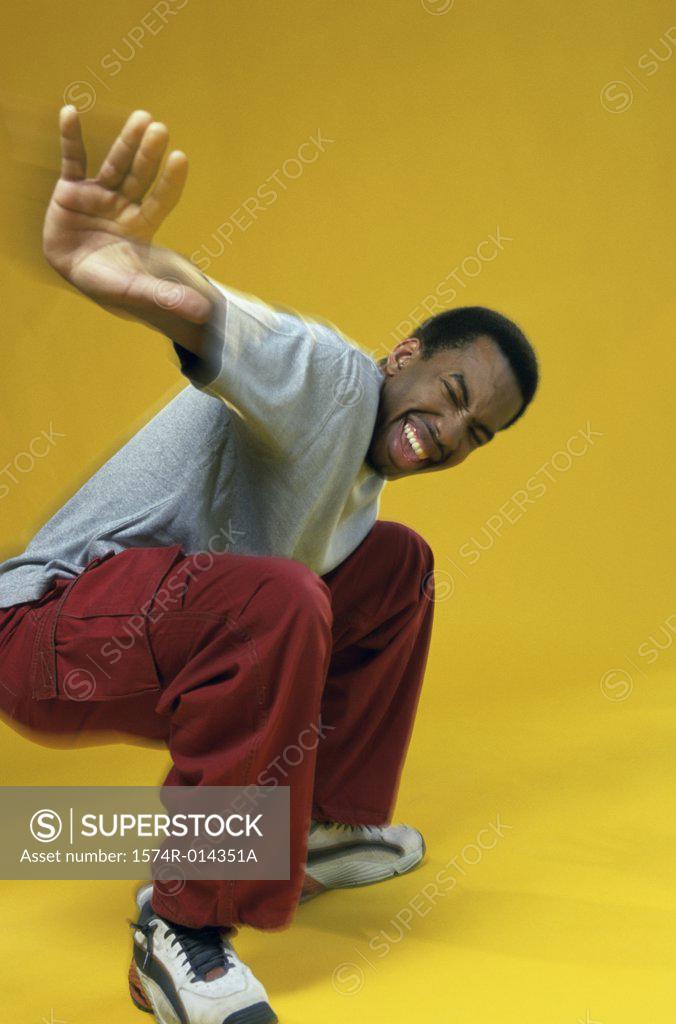 Stock Photo: 1574R-014351A Side profile of a young man showing a stop gesture