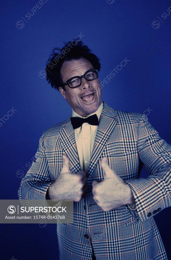 Stock Photo: 1574R-014376B Portrait of a mid adult man showing a thumbs up sign