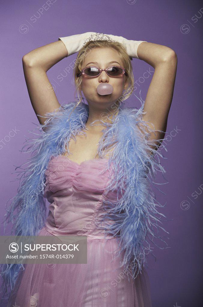 Stock Photo: 1574R-014379 Portrait of a young woman blowing bubble gum