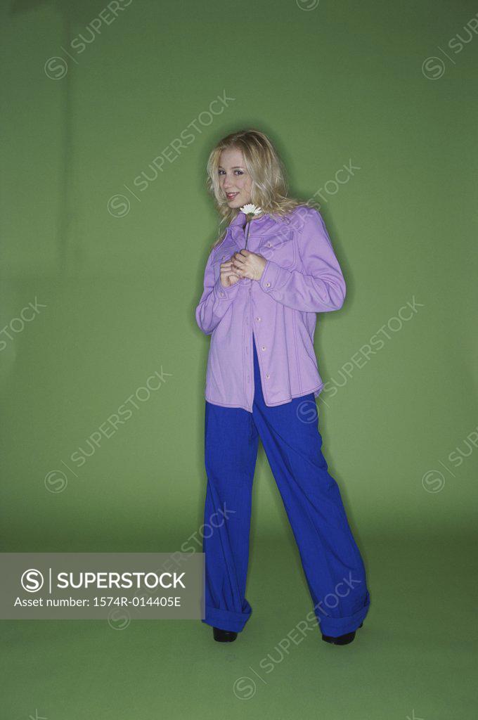Stock Photo: 1574R-014405E Portrait of a teenage girl holding a flower
