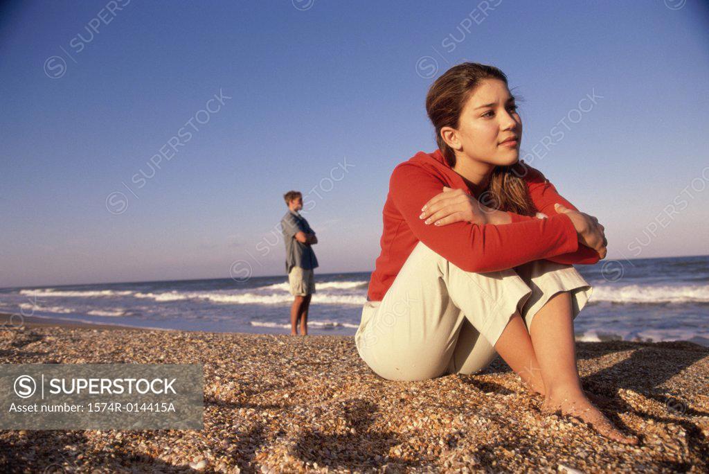 Stock Photo: 1574R-014415A Close-up of a teenage girl sitting on sand
