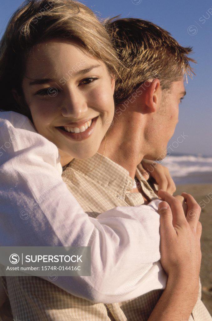 Stock Photo: 1574R-014416C Portrait of a teenage girl hugging a young man