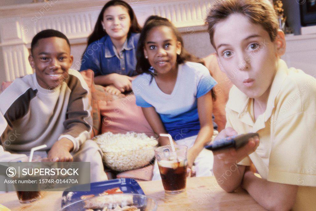 Stock Photo: 1574R-014470A Portrait of two teenage boys and two teenage girls watching television together