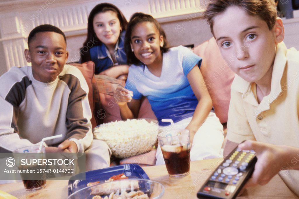 Stock Photo: 1574R-014470C Two teenage girls and two teenage boys watching television