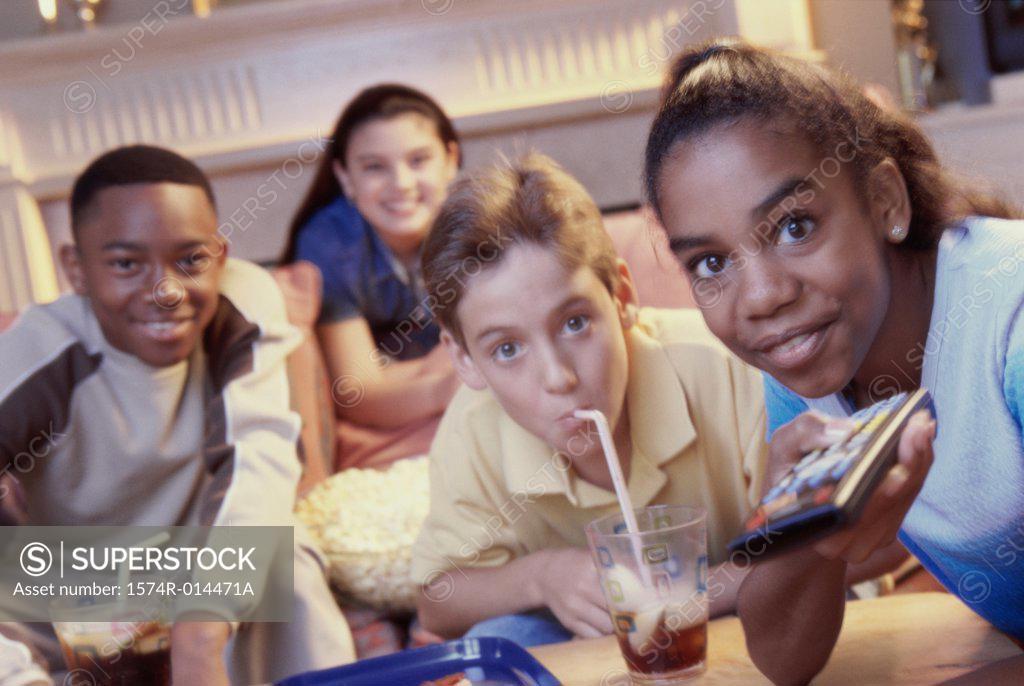 Stock Photo: 1574R-014471A Portrait of two teenage girls and two teenage boys watching television together