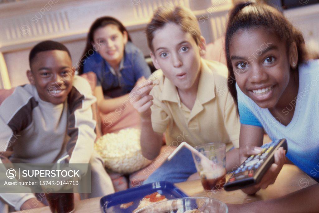 Stock Photo: 1574R-014471B Two teenage girls and two teenage boys watching television