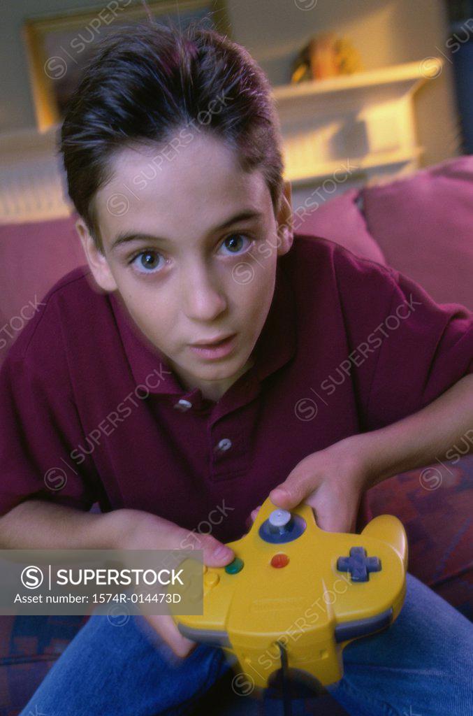 Stock Photo: 1574R-014473D Portrait of a teenage boy playing video games