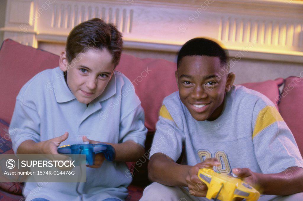 Stock Photo: 1574R-014476G Portrait of two teenage boys playing video games