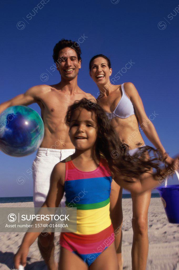 Stock Photo: 1574R-014480A Low angle view of parents and their daughter standing on the beach