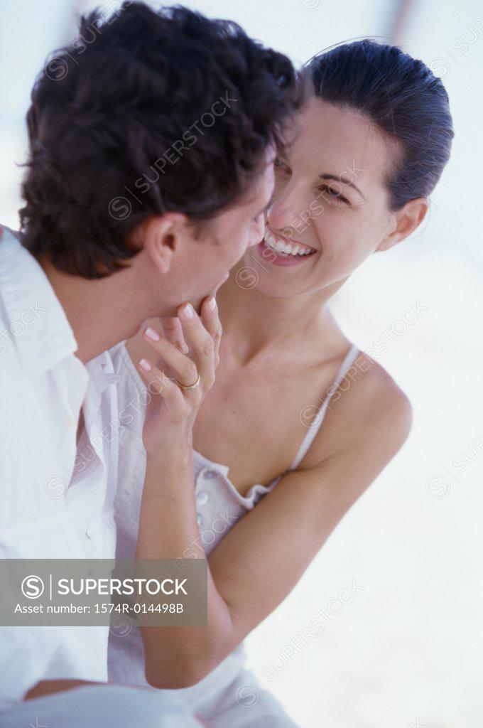 Stock Photo: 1574R-014498B Close-up of a young woman touching the face of a young man