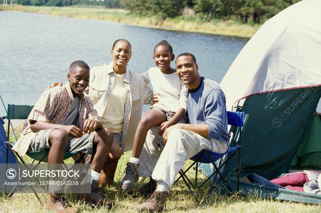 Stock Photo: 1574R-014525B Portrait of parents sitting at a campsite with their son and daughter